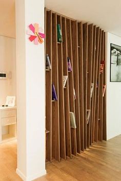 a room with some bookshelves made out of wooden slats and shelves on the wall