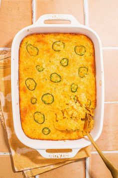 a casserole dish with zucchini and cheese in it on a table