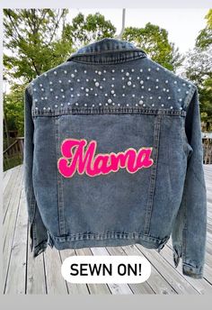 a denim jacket with the word mama on it and sequins in pink letters