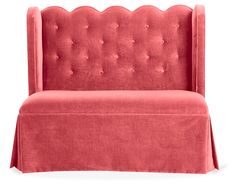 an upholstered red couch with a ruffled skirt on it's back