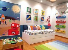 a child's bedroom with toys and artwork on the walls