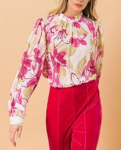 Our Ashley floral blouse is both sophisticated and fun!  A stunning abstract floral print in pink and taupe on a white base gives this blouse an edge, while billowy sleeves offer a feminine appeal.  Gathering at the collar, sleeves and shoulders add that extra flair.  Effortlessly pair this blouse with jeans for a casual look or dress up with your favorite bottoms. Feminine Pink Blouse For Fall, Pink Blouse With Blouson Sleeves For Fall, Cream Floral Print Feminine Blouse, Feminine Pink Blouse With Blouson Sleeves, Chic Cream Blouse With Floral Print, Pink Workwear Top With Blouson Sleeves, Pink Blouson Sleeve Top For Work, Cream Floral Print Blouse For Fall, Spring Cream Printed Blouse