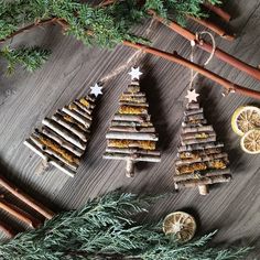 christmas tree made out of sticks and lemon slices on a table with cinnamon stick decorations