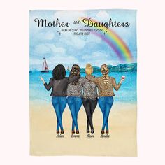 three women are standing on the beach with their arms around each other and one is holding a rainbow