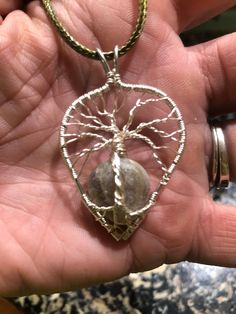 This piece features a small beach stone tied into the bottom of a tree of life design. Resembling the ground and tree roots. The tree is hand woven with silver coated copper wire and the stone is a gray/light brown color. Each of the pieces that I create are made from sea glass and beach stones that I personally find while beach combing on Nantucket Island. Take a piece of this special island with you. Silver Tree Of Life Necklace For Healing, Spiritual Silver Necklace With Copper Wire, Earthy Hand-wrapped Natural Jewelry, Earthy Hand Wrapped Natural Jewelry, Tree Of Life Design, Nantucket Island, Light Brown Color, Tree Roots, Tree Of Life Necklace