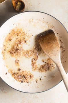 a wooden spoon in a dirty white plate