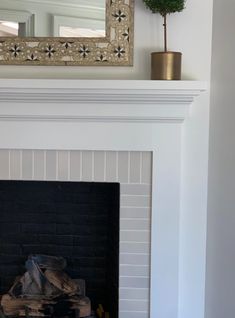 a fire place with a mirror above it