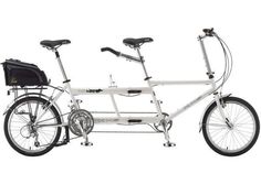 a white bicycle with two bicycles attached to the front and rear wheel, on a white background