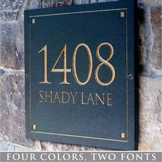 a black and gold plaque with the name shady lane written in gold lettering on it