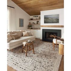 a living room filled with furniture and a fire place under a wooden ceiling mounted above a fireplace