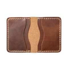 A Leather Wallet with unparalleled attention to detail.Upon holding this Natural colored wallet, you will immediately appreciate the craftsmanship. We take the time to hand-stitch every component of this wallet. We sand, burnish and polish the edges for an even, smooth feel. The soft, supple, leather feels lightweight yet durable at the same time. You won't be able to find this level of quality in a department store.Our full-grain leather means your wallet will develop character and patina. We h Handmade Brown Wallet For Everyday Carry, Handmade Leather Wallets For Everyday Carry, Artisan Hand-stitched Wallets For Everyday Use, Handmade Classic Wallet, Artisan Hand-stitched Wallets, Hand-stitched Bifold Card Holder For Everyday Use, Classic Hand-stitched Wallets As Gifts, Artisan Brown Wallets With Interior Card Slots, Artisan Leather Rectangular Card Holder