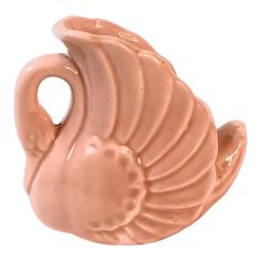 a pink ceramic vase shaped like a bird