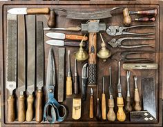 a wooden box filled with lots of different types of kitchen utensils and knives