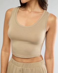 Made from heathered jersey, this fitted tank is designed with a scoopneck and a hem cut to sit at the natural waist. Scoop neck Sits at natural waist Fitted Heather jersey 96% Tencel 4% Spandex The Scoop Tank is styled with the Boxer Pajama Short. Everyday Solid Scoop Neck Crop Top, Everyday Solid Color Scoop Neck Crop Top, Cotton Tank Top With Scoop Back, Solid Cotton Tank Top With Scoop Back, Cotton Solid Color Tank Top With Scoop Back, Casual Tank Top With Scoop Back And Seamless Construction, Fitted Beige Crew Neck Tank Top, Scoop Back Tank Top For Everyday, Everyday Solid Color Tank Top With Scoop Back