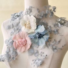 a mannequin with flowers on it's back and silver sequins