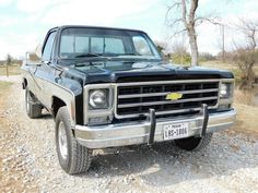 an old pickup truck is parked on the gravel