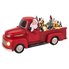 a red truck with santa claus in the back