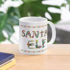 a santa fe mug sitting on top of a wooden table