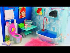 this is a dollhouse bathroom with princess ariel the little mermaid and her bathtub