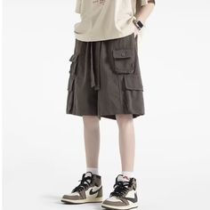 Take your wardrobe to the next level with these stylish Solid Multi-Pocket Cargo Shorts. Featuring multiple pockets for convenience, they offer an aesthetically pleasing accent to any outfit. With a wide range of sizes, they are perfect for a night out, casual event, or everyday use. Features: -100% Polyester -Mid-rise waist -Belted Waistband -Multi-Pocket -Solid Color -Regular Fit -Vintage style Baggy Utility Shorts With Pockets, Baggy Utility Shorts With Side Pockets, Baggy Cargo Shorts With Pockets For Summer, Summer Streetwear Cargo Pants With Pockets, Baggy Wide-leg Shorts With Pockets, Casual Baggy Shorts With Pockets, Khaki Utility Bottoms With Pockets, Solid Color Cargo Shorts With Pockets For Streetwear, Casual Multi-pocket Cargo Shorts For Streetwear