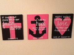 three pink and black wall hangings with an anchor, heart, and words on them