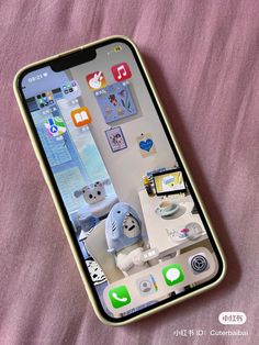 an iphone is sitting on a bed with stickers all over the phone's screen