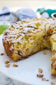 a close up of a cake on a plate with one slice cut out and the other half eaten