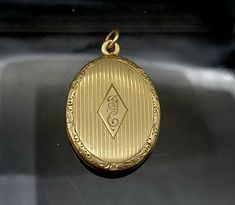 "This beautiful Vintage solid 14K Gold locket is in pristine condition. It features very fine engraving on the face centered with the scripted initials \"D\" and \"C\". The closure on this locket snaps tight and is extremely secure. This locket measures 1 1/2\" in height and 7/8\" in width and it weighs 7.3 grams. *Please note: The chain pictured in one of the thumbnails does not come with this locket." Classic Oval Locket Necklace Stamped 14k, Classic 14k Stamped Medallion Locket Necklace, Classic 14k Gold Locket Necklace For Formal Occasions, Timeless Engraved Locket Necklace For Formal Occasions, Classic Pendant Locket Necklace For Formal Occasions, Antique Oval 14k Gold Locket Necklace, Classic 14k Gold Hallmarked Locket Necklace, Classic Yellow Gold Oval Locket Necklace, Classic 14k Gold Locket Necklace