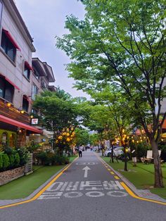 an empty street with people walking down it