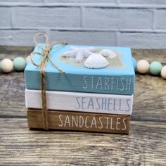 three books stacked on top of each other with the words starfish seashells sandcastles