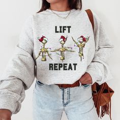 Lift Repeat Sweatshirt, Funny Christmas Workout Shirt, Merry X-mas, Funny Xmas Gym Training Fitness Gift ABOUT: :) This pre-shrunk, classic fit sweatshirt is made with air-jet spun yarn for a soft feel and reduced pilling. :) Pre-shrunk :) Classic fit with no center crease :) 1x1 athletic rib knit collar with spandex :) Air-jet spun yarn with a soft feel and reduced pilling :) Double-needle stitched collar, shoulders, armholes, cuffs, and hem: 50% preshrunk cotton, 50% polyester and like colors. Christmas Workout Shirts, Gym Swag, Christmas Workout, Fitness Gift, Photo Care, Funny Xmas, Fitness Gifts, Funny Sweatshirts, Workout Sweatshirt