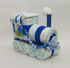 a blue and white diaper set sitting on top of each other next to a toothbrush