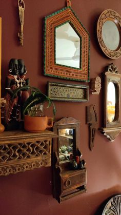 there are many mirrors and other decorative items on the wall