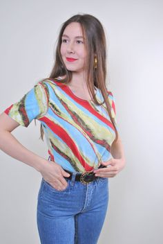 "Abstract print women holiday multicolor tshirt for festival, Size M Welcome to TARASCOMMON.ETSY.COM Unique clothing from the 20th century. Model tall - 170cm M. Sleeve - 8cm / 3.14inch; ( armpit to end of sleeve); Width - 40cm / 15.74inch; Length - 55cm / 21.65inch. All measurements are taken seam to seam while lying flat. Viscose. This item is vintage, so it can have some defects. Additional photos can be send We are glad that you are interested in lots that we sell. Wish you a good shopping! Vintage Multicolor Print Top, Retro Green Printed T-shirt, Vintage Printed Tops For Festival, Colorful Short Sleeve Tops For Festival, Colorful Short Sleeve Festival Tops, Festival Multicolor Print Short Sleeve Tops, Vintage Multicolor Crew Neck Tops, Multicolor Graphic Print Festival T-shirt, Vintage Fitted Multicolor Print Tops