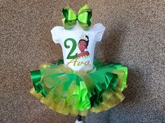 This set includes a shirt, tutu and bow! Available in sizes 3 months to 10 years. *Please be sure to include name and age at checkout* Request a custom tutu! We can do any color or color variation. All of our tutu's are beautifully sewn and double layered. They are made with yards and yards of 100% high quality diamond net nylon tulle and  soft satin ribbon with a versatile elastic waist band. Make sure to check out all the sizing charts located in the pictures. WASHING INSTRUCTIONS Please, keep Princess And The Frog Birthday Outfit, Princess Tiana 1st Birthday Party, Princess And The Frog Birthday Theme, Princess And The Frog 1st Birthday Party, Princess And The Frog First Birthday, Princess And The Frog Themed Party, Princess And The Frog Birthday Party, Princess And The Frog Party, Childhood Birthday