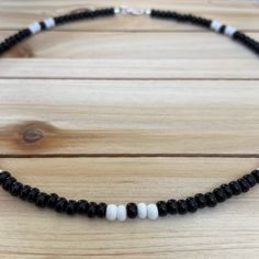 The Black & White beaded choker can go with any outfit. Whether you are out at dinner or a party on the beach, this choker is just what you need! All chokers are customizable to the size you need so please be sure to measure your neck where you want your choker to sit and order accordingly! This high quality beaded choker is beautiful worn on its own or layered. It is secured with a sterling silver lobster claw and made with glass beads that can stand the test of time, making it perfect for Summer Black Beaded Round Necklaces, Summer Beaded Necklace With Black Round Beads, Black Beaded Necklaces With Spacer Beads For Beach, Black Beaded Choker Necklace As Gift, Black Beaded Necklace For Beach With Tiny Beads, Black Beaded Necklace With Letter Beads, Black Beaded Necklace With Letter And Round Beads, Adjustable Black Beaded Necklace With Letter Beads, Beach Black Beaded Necklace With Tiny Beads