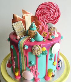 a colorful cake decorated with candy, candies and lollipops