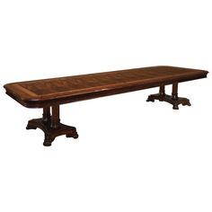 a large wooden table with two pedestals on each side