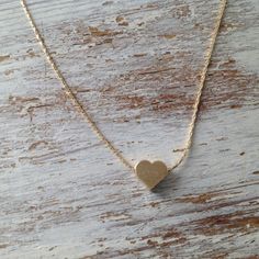 Cute gold necklace with a tiny heart charm hangs on a delicate 14k gold filled chain .This necklace is perfect for yourself, giving as a special gift.Necklace Measures Approximately 17"Tiny heard bead- 7 mmMade from 14k gold filled .If you would like this chain altered, please convo me. All my jewelry are packed in an elegant gift box.If you want to give it as a gift you can specify the address and I'll be happy to send it on your behalf. Dainty Small Charm Necklace For Everyday, Dainty Charm Necklaces With Heart Beads For Gift, Dainty Heart Beads Charm Necklace For Gift, Dainty Charm Necklace With Heart Beads For Gift, Minimalist 14k Gold Filled Open Heart Jewelry, Dainty Everyday Heart Charm Necklace, Simple 14k Gold Jewelry With Heart Charm, Everyday 14k Gold Open Heart Charm Necklace, 14k Gold Filled Heart Pendant Charm Necklace Gift