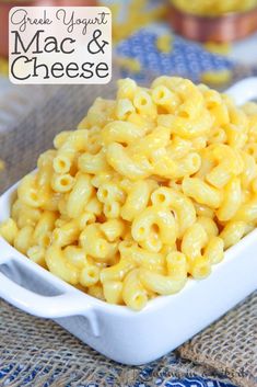 a white bowl filled with macaroni and cheese on top of a blue table cloth