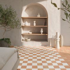 a bed sitting next to a shelf filled with vases