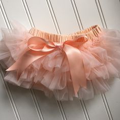 Introducing our delightful Peach Tutu Bloomer with All-Around Ruffles! Spoil your little one with this adorable baby bloomer, featuring a charming peach color and ruffles that encircle the entire bloomer. It's the perfect addition to your child's wardrobe, whether they're wearing it under a dress, paired with a baby costume, or for capturing those precious moments during a photoshoot! Crafted for optimal comfort, this bloomer is made from soft and breathable fabric, ensuring a cozy and gentle fe Cute Pink Bloomers For Playtime, Playful Pink Diaper Cover For Spring, Pink Cute Diaper Cover For Spring, Spring Playtime Pink Diaper Cover, Pink Ruffled Bottoms For Playtime, Baby Kostüm, Baby Costume, Baby Bloomers, Baby Costumes