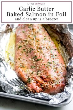 a piece of salmon in foil with some seasoning on the top and one side