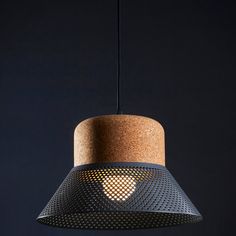 a light hanging from a ceiling with a wooden base and mesh design on the bottom