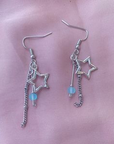 silver-toned shooting star charm earrings with sea-blue glass bead *note some natural tarnish on star charms Metal Dangle Earrings With Star Charm, Celestial Silver Earrings With Dangling Charms, Silver Celestial Earrings With Dangling Charms, Trendy Silver Star Charm Earrings, Sterling Silver Star Earrings With Dangling Charms, Trendy Silver Earrings With Star Charm, Star-shaped Metal Jewelry With Dangling Charms, Silver Star-shaped Jewelry With Dangling Charms, Blue Star Charm Dangle Earrings