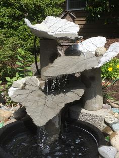 a water fountain in the middle of a garden