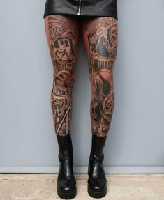 a woman with tattoos on her legs and leggings