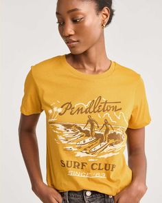 Made from soft 100% cotton, featuring a vintage-inspired graphic of a west-coast surf session. 100% cotton. Imported. | WOMEN'S SURF CLUB GRAPHIC TEE Surf Club, Surf Tee, Surf Shirt, Baby Fabric, Graphic Tee Shirt, Graphic Tee Shirts, Graphic Tees Women, Pajamas Women, Summer Looks