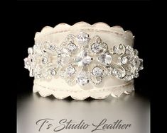 Rhinestone & Leather Rustic Wedding Ivory Bridal Cuff Bracelet Wristband So romantic! A vintage style leather cuff bracelet perfect for a rustic wedding, or an accessory for every day elegance. Made with genuine leather that has been stained with leather paint, then antiqued for a vintage look, and accented with sparkling cubic zirconia rhinestone crystals. I am happy to accept custom orders. Please contact me for a customization of this bracelet. PLEASE READ MY SHOP POLICIES BEFORE PLACING Bridal Cuff Bracelet, Bridal Cuff, Leather Cuff Bracelet, Ivory Bridal, Leather Paint, Leather Cuffs Bracelet, Leather Cuffs, Wedding Bracelet, Shop Policies