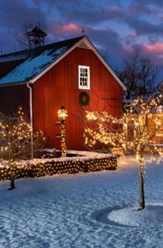 a red barn with christmas lights on it